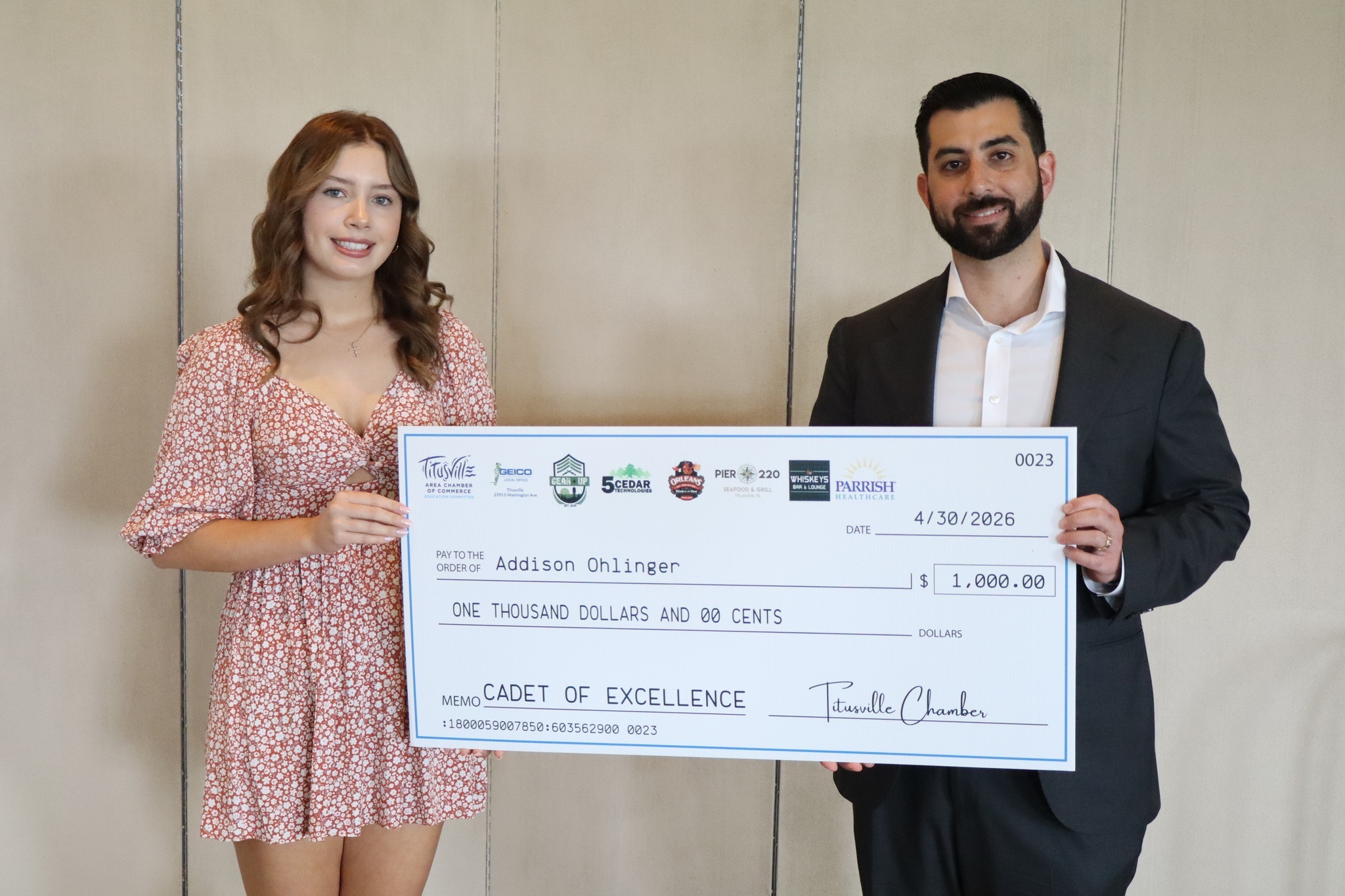 Amer Hatoum of Gear Up Surplus and 5 Cedar Technologies presenting a Cadet of Excellence Scholarship check